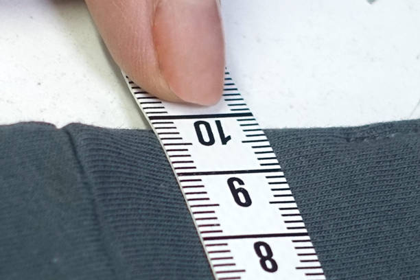 istock Hands of designer at work with fabric close-up 864543414