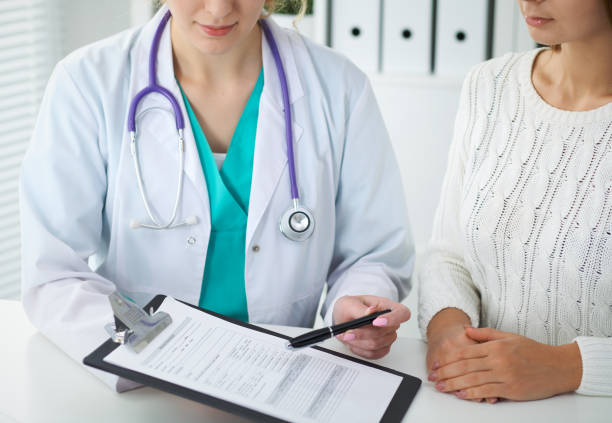Doctor and patient, close-up of hands. Physician talking about medical examination results. Medicine, healthcare and helping concept
