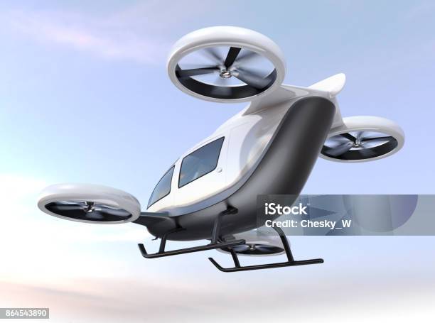 White Selfdriving Passenger Drone Flying In The Sky Stock Photo - Download Image Now