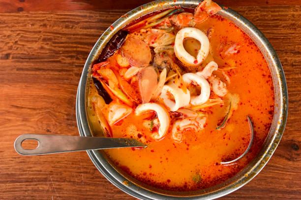istock Tom Yum Goong put on a wooden table top view 864544000