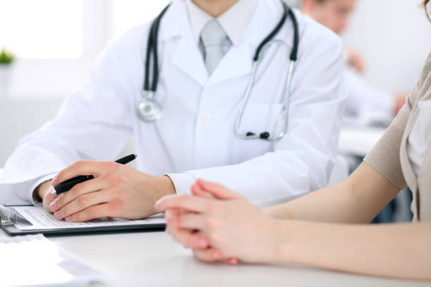 istock Doctor and patient are discussing something, just hands at the table 864544144