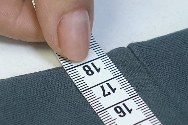 istock Hands of designer at work with fabric close-up 864544196