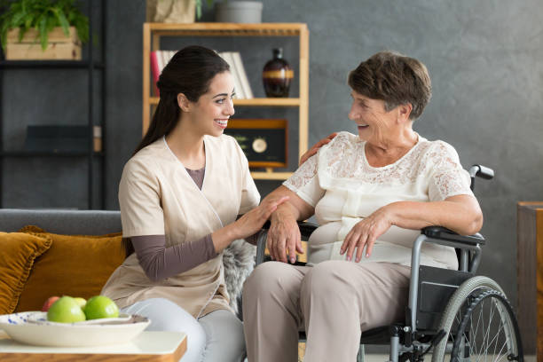 smiling daughter and disabled mother - diabetes home interior blood sugar test healthcare and medicine imagens e fotografias de stock