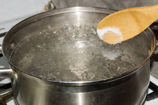 istock In boiling water pour salt with a wooden spoon. 864547922