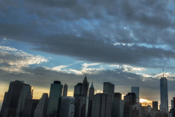 istock Wall street buildings on the brooklyn bridge at sunset time 864548652
