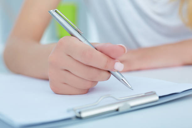 istock Business woman making notes at office workplace closeup. 864550540