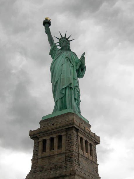 istock Statue of liberty seen from the front with a grey and cloudy sky. 864551266