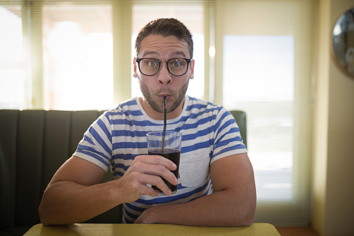 Portrait of man having drink in restaurant