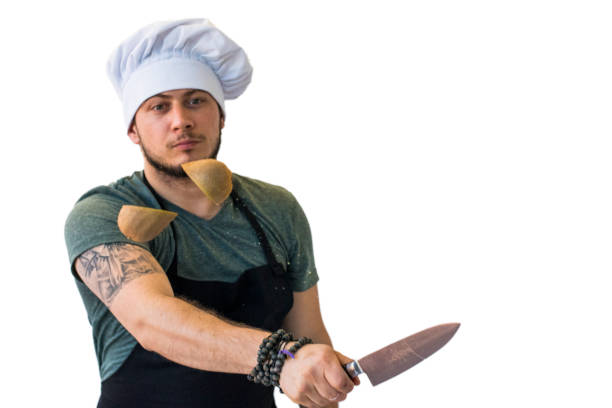 istock Chef cutting kiwi in the air 864556684