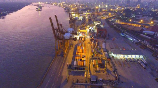 istock Logistics and transportation of Container Cargo ship and Cargo working crane bridge in shipyard 864557318