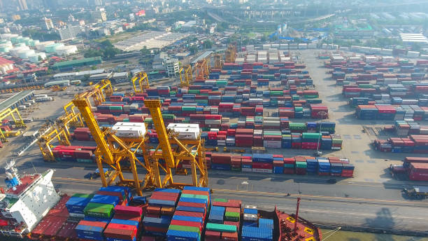 istock Logistics and transportation of Container Cargo ship and Cargo working crane bridge in shipyard 864557370