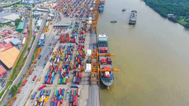istock Logistics and transportation of Container Cargo ship and Cargo working crane bridge in shipyard 864557432