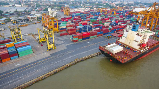 istock Logistics and transportation of Container Cargo ship and Cargo working crane bridge in shipyard 864557568