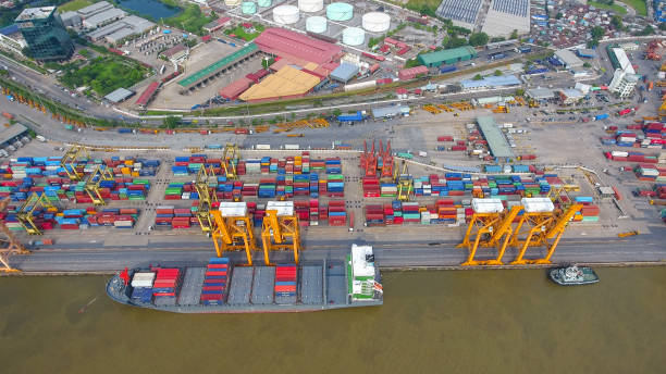 istock Logistics and transportation of Container Cargo ship and Cargo working crane bridge in shipyard 864557628