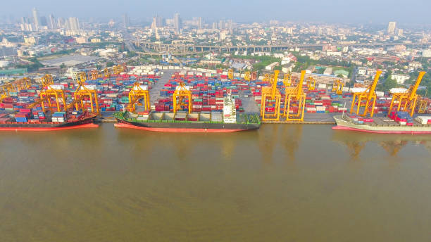 istock Logistics and transportation of Container Cargo ship and Cargo working crane bridge in shipyard 864557704