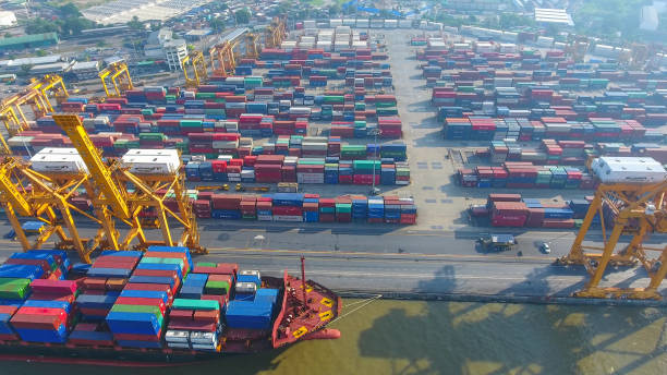 istock Logistics and transportation of Container Cargo ship and Cargo working crane bridge in shipyard 864558206