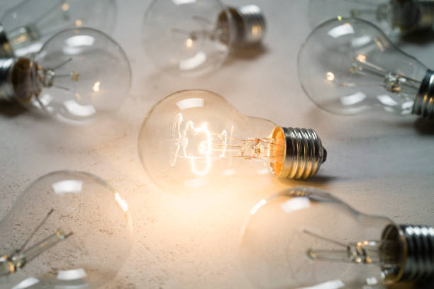 istock Group of vintage bulbs on concrete background 864559034