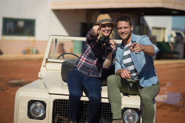 istock Couple sitting together on a car 864563194