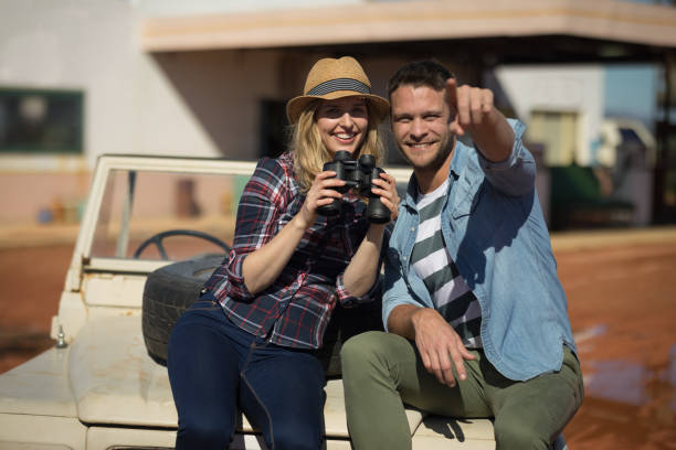 istock Couple sitting together on a car 864563710