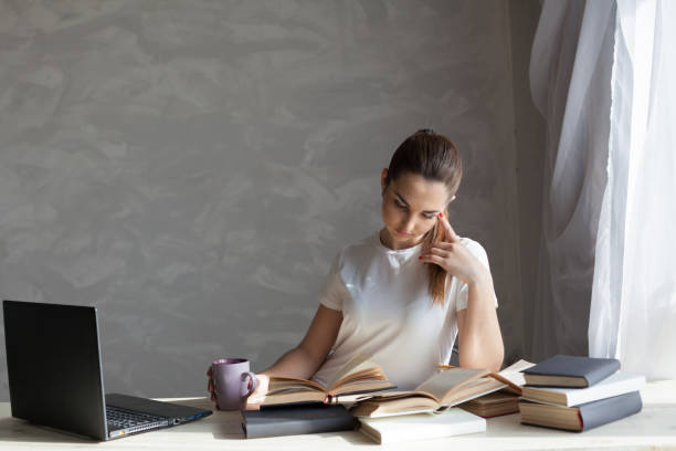 istock girl reading a book and drinking coffee 864564794