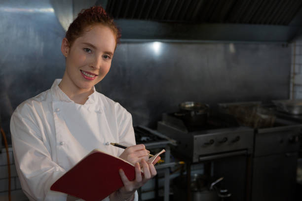 istock Female chef taking down an order in the book 864565044