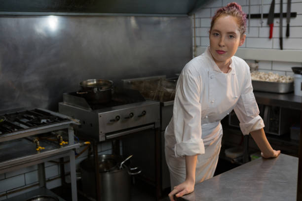 istock Female chef standing in the kitchen 864565070