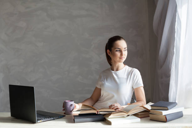 istock girl reading a book and drinking coffee 864565174