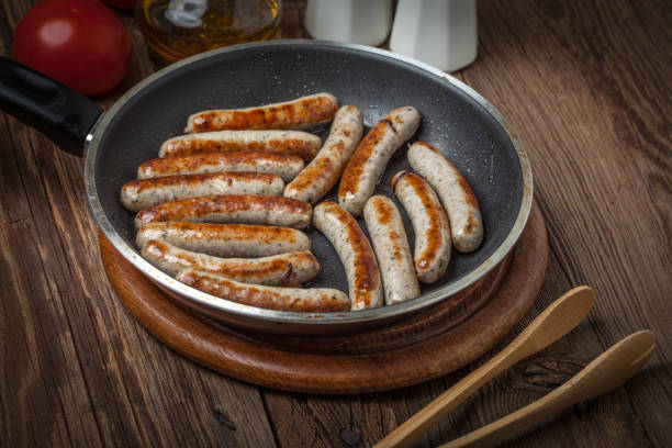istock Fried white sausages in a cast iron skillet. 864568582