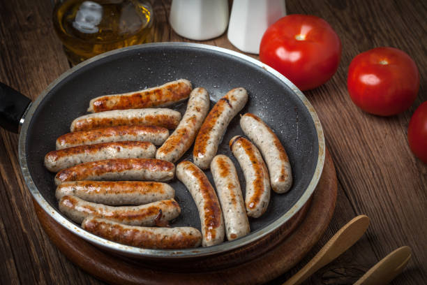 istock Fried white sausages in a cast iron skillet. 864568712