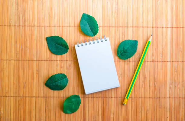 istock Notepad with pencil on wood board background.using wallpaper for education, business photo.Take note of the product for book with paper and 864569620