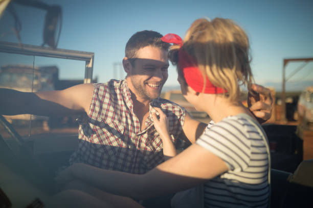 istock Couple interacting with each other in a car 864572908