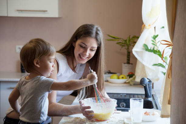 istock mother and young son prepare pie in the kitchen 864573472