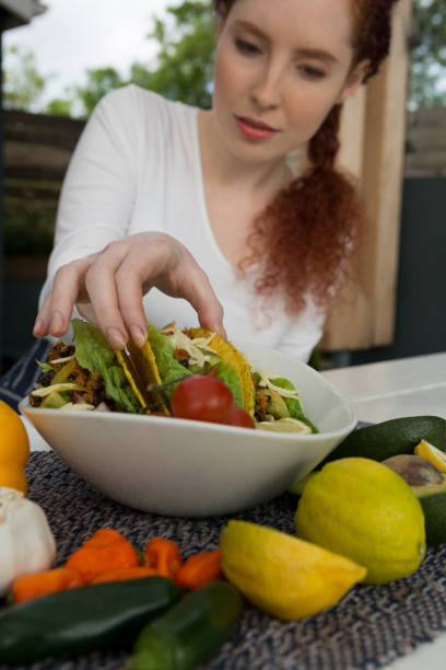 istock Woman eating mexican food 864574750