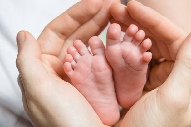 istock Father hugs his newborn baby feet 864577366
