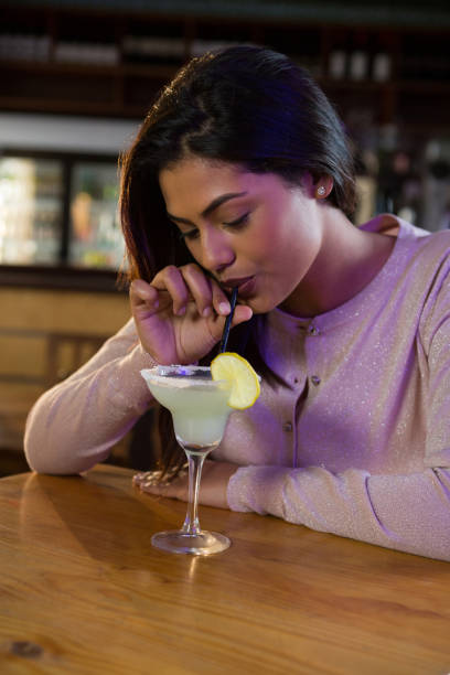 istock Woman sipping on a drink 864578864