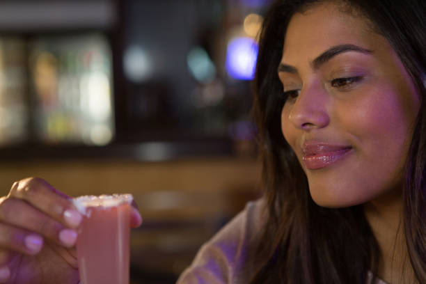 istock Woman drinking tequila shot 864579060