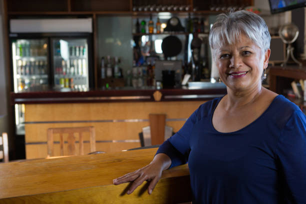 istock Waitress standing near cafe counter 864579736