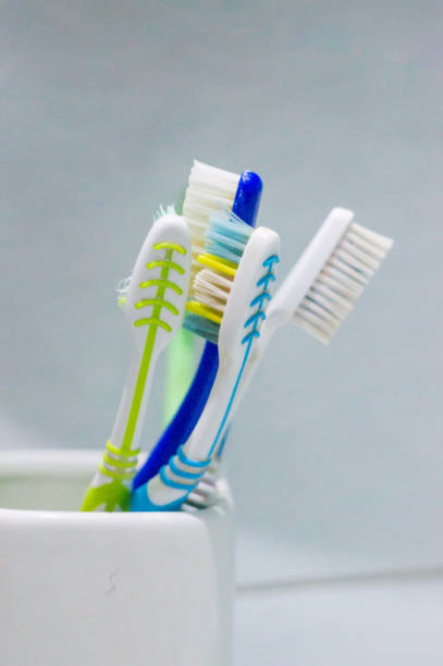 istock toothbrushes in a white glass in the bathroom 864580650