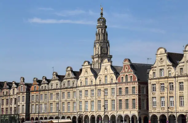 Historical gables of houses and tower of the cathedral on the Grand Place in Arras, France