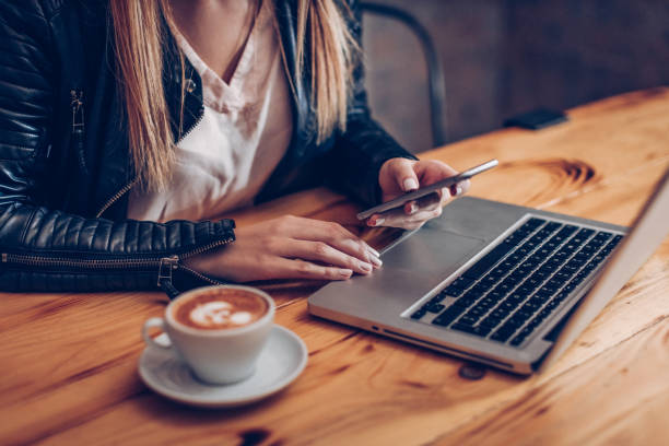 istock Woman texting on her phone at a cafe 864581720
