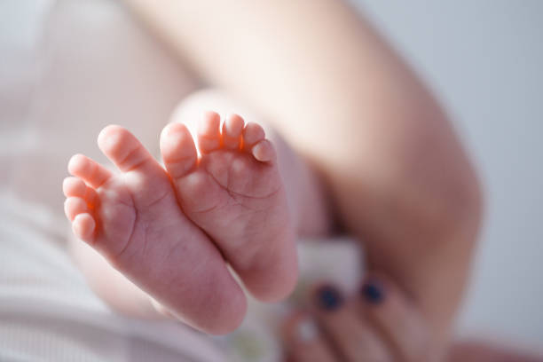 istock Newborn baby feet close up 864581734