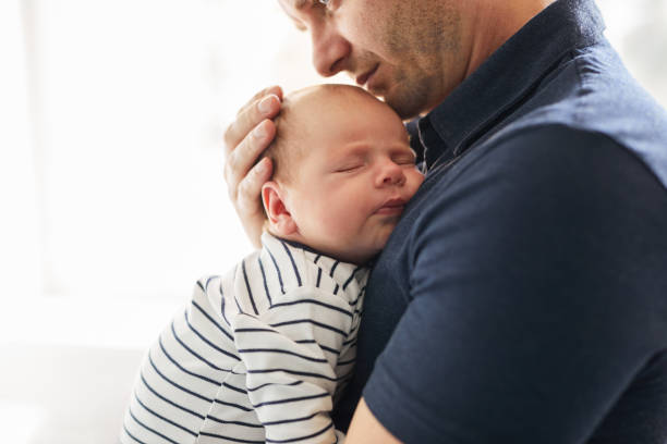 istock Father holding her newborn baby 864582054
