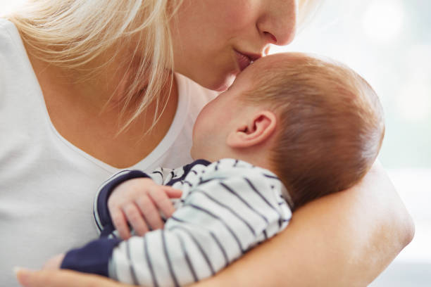 istock Mother kissing her cute son 864582100