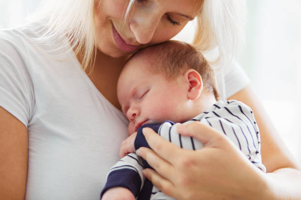 istock Mother holding her newborn baby 864582108