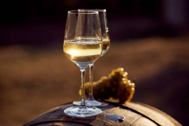 istock Two glasses of white wine at sunset 864582174