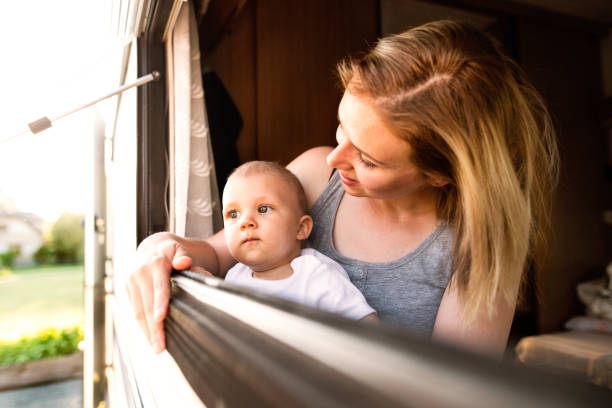 istock Mother and baby son in a camper van. 864582216