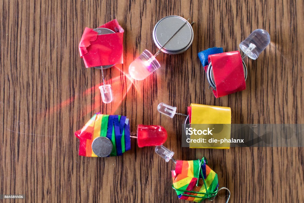 Educational electronic activity for children Led Series and colored insulating taper with flat batteries. Educational electronic activity for children Battery Stock Photo