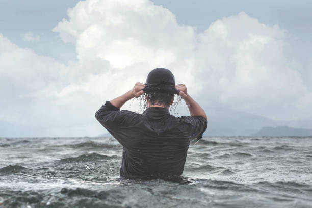 istock surreal businessman wearing wet hat 864584600