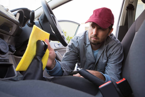 istock Auto service staff cleaning car interior 864587518