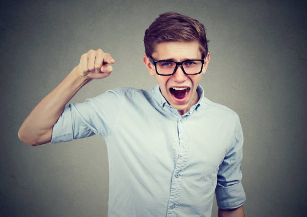 istock Angry teenager man accusing someone screaming pointing finger at camera 864589494